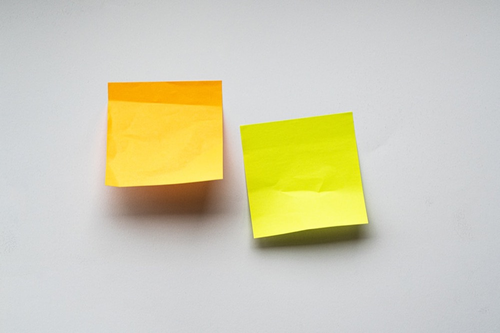 Colorful sticky notes covering a wall, representing scattered thoughts