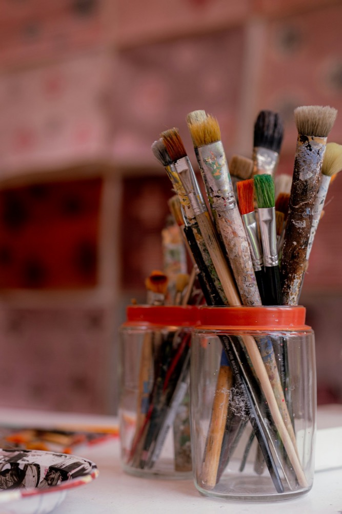 Paintbrushes resting in a glass jar, ready for creative expression
