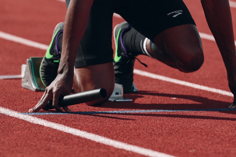 A runner focused and in stride on an open field