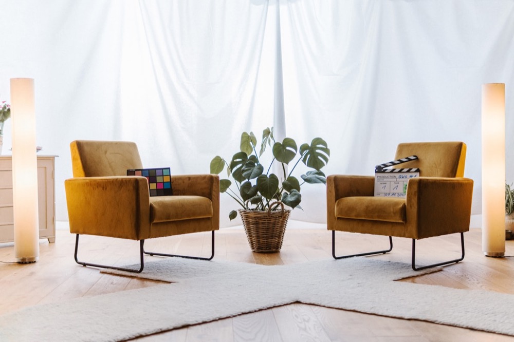A calm, softly lit therapy office with two chairs and a plant