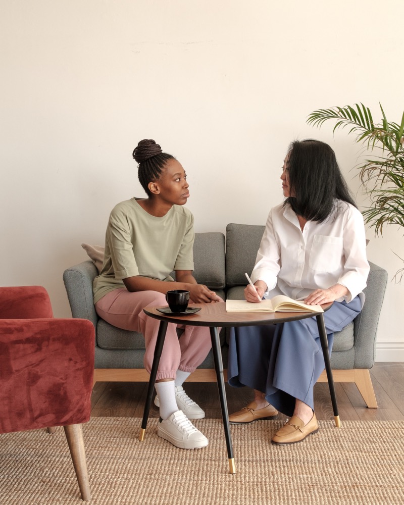 Two women having a supportive conversation about anxiety, depression, and mood