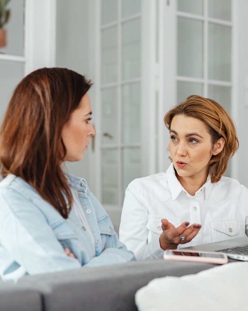 Two clinicians in a focused discussion during a consultation or supervision session